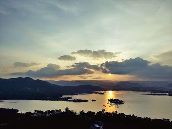 Scenic view of lake against sky during sunset