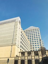 Low angle view of modern building against clear blue sky