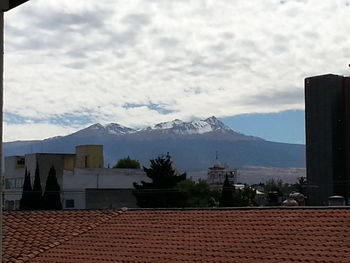 Scenic view of mountains against cloudy sky
