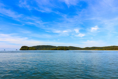 Scenic view of sea against blue sky