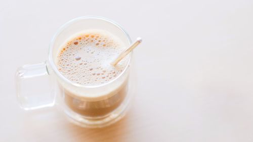 High angle view of coffee cup against white background