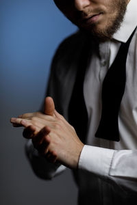Side view of businessman gesturing against white background