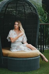 Portrait of young woman sitting outdoors