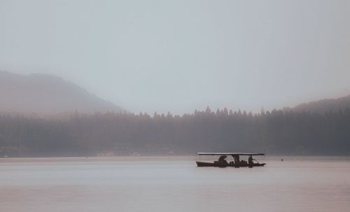 Scenic view of lake against sky during winter