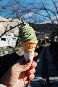 Cropped hand holding ice cream cone