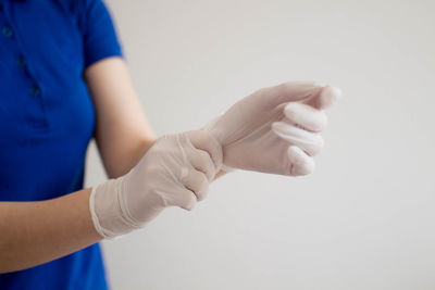 Close-up of woman hand over white background