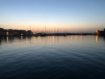 Sailboats in marina at sunset