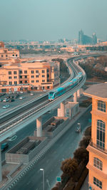 High angle view of road amidst buildings in city against sky