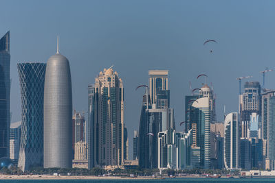 Skyscrapers in city against clear sky