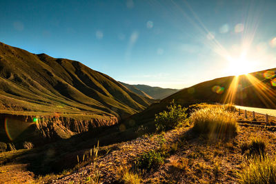 Scenic view of field against sky during sunset