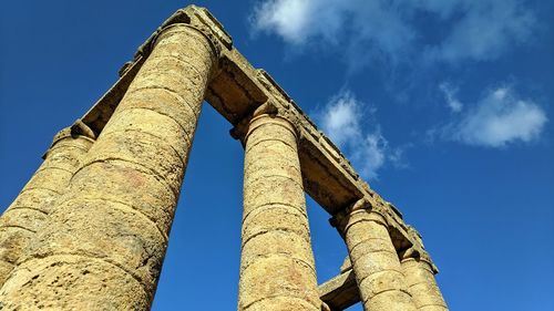 Low angle view of historical building against blue sky