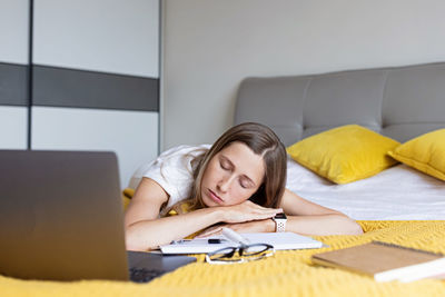 Young woman using laptop at home