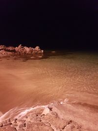 Scenic view of desert against sky at night
