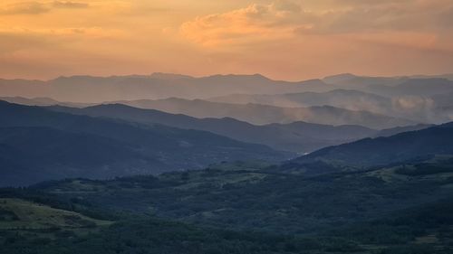 Scenic view of mountains against sky during sunset