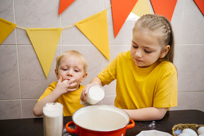 Kids prepare dough for holiday cupcake holiday easter, eggs on the table