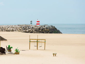 Lifeguard hut on beach against clear sky