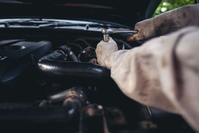 Close-up of man working on car