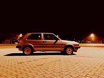 Car on illuminated street at night