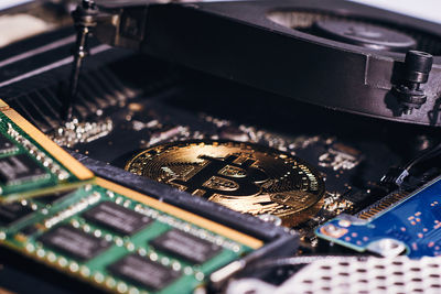 Close-up of bitcoin with computer equipment