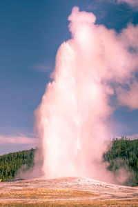 Scenic view of waterfall against sky