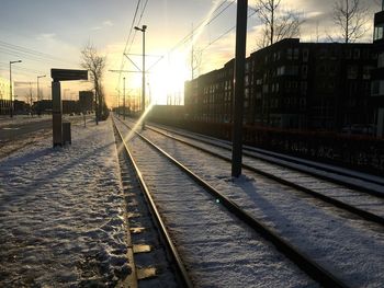 Railway tracks against sky during winter