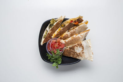 High angle view of food in plate against white background