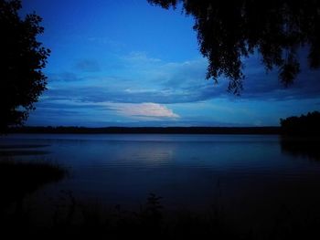 Scenic view of lake against sky at sunset