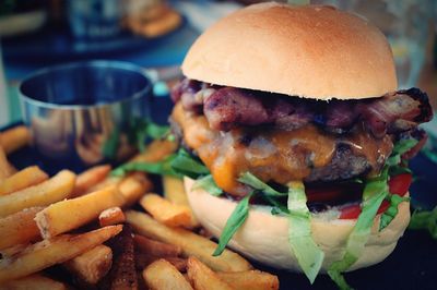 Close-up of burger with french fries on table