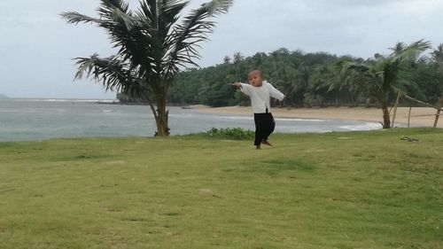 Full length of man on palm tree