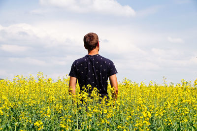 Rear view of man standing in field