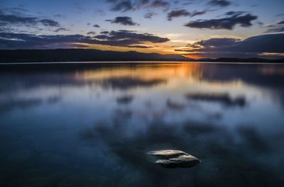 Scenic view of lake against sky during sunset