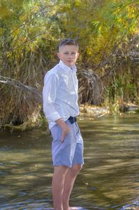 Portrait of young man standing by creek at cherry creek state park