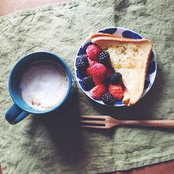 Directly above shot of beard and fruits with coffee on table