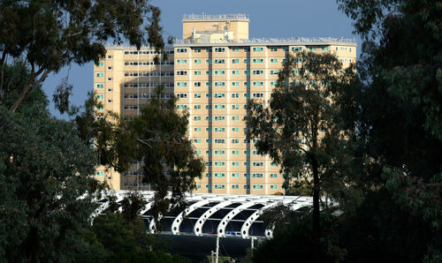 High angle view of building by trees against sky