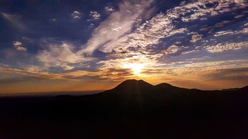 Scenic view of mountains against sky at sunset