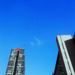 Low angle view of building against clear blue sky
