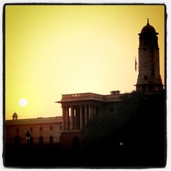 Low angle view of built structures at sunset