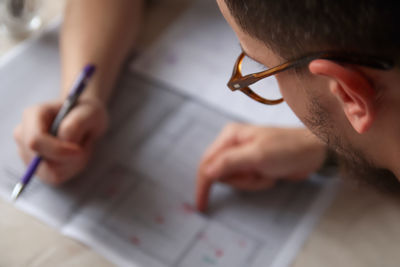 Close-up of man working at table