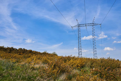 Low angle view of electricity pylon against sky