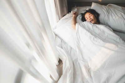 Young woman sleeping in bed