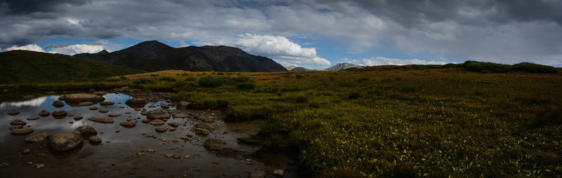 Scenic view of mountains against cloudy sky