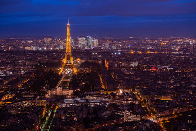 Aerial view of city lit up at night