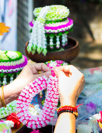 Close-up of hand holding pink flowers