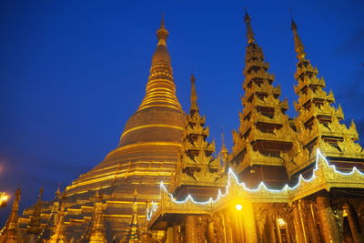 Low angle view of illuminated historic building against sky