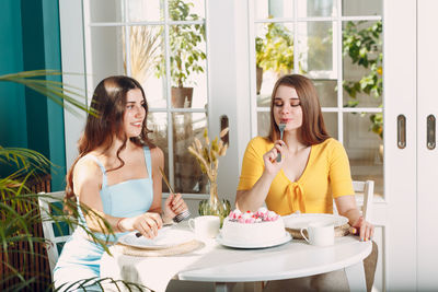 Young woman sitting on table