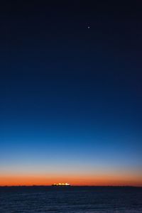 Scenic view of sea against clear sky at night