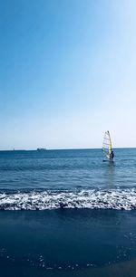 Sailboat in sea against clear sky