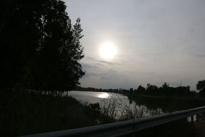 View of calm lake against cloudy sky