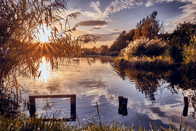 Scenic view of lake against sky at sunset