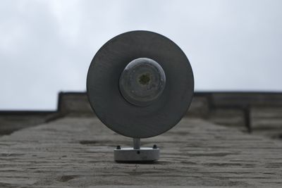 Close-up of coin-operated binoculars against sky